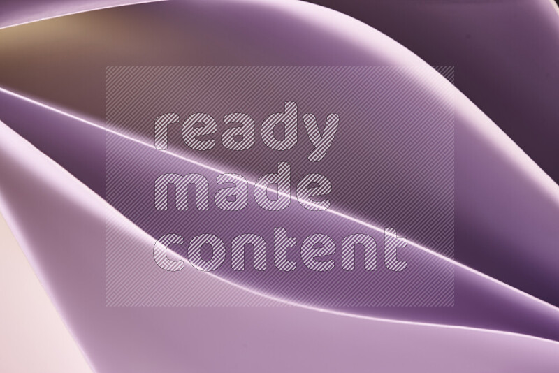 This image showcases an abstract paper art composition with paper curves in purple and gold gradients created by colored light
