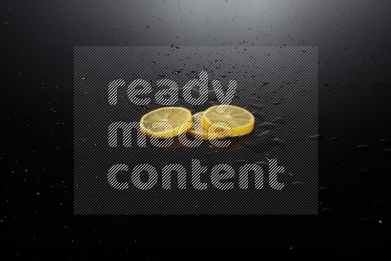 Lemon slices with water drops, and droplets on black background