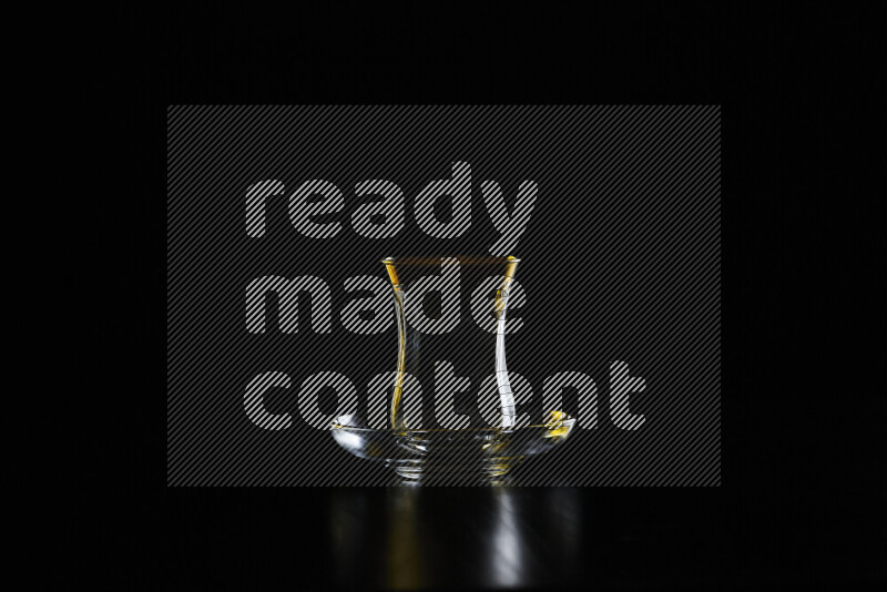 Glassware with rim light in yellow and white against black background