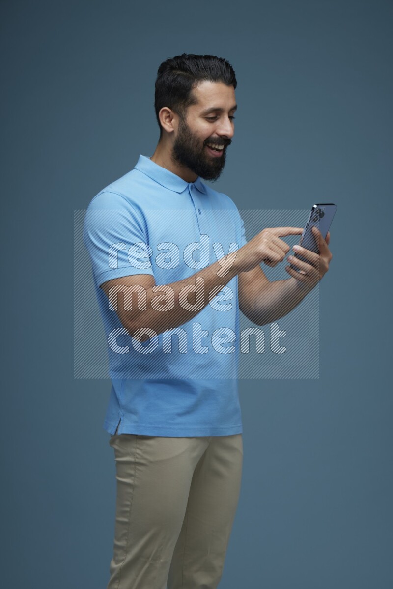 A man Swiping in a blue background wearing a Blue shirt