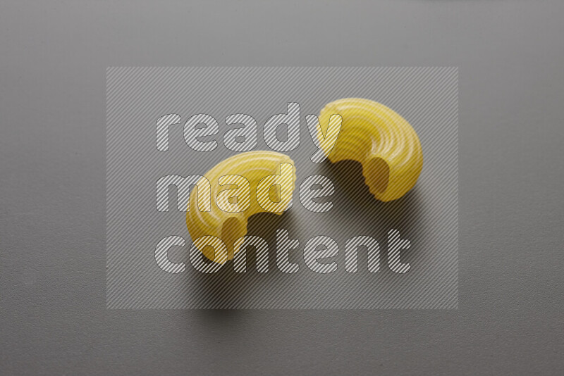 Elbow pasta on grey background