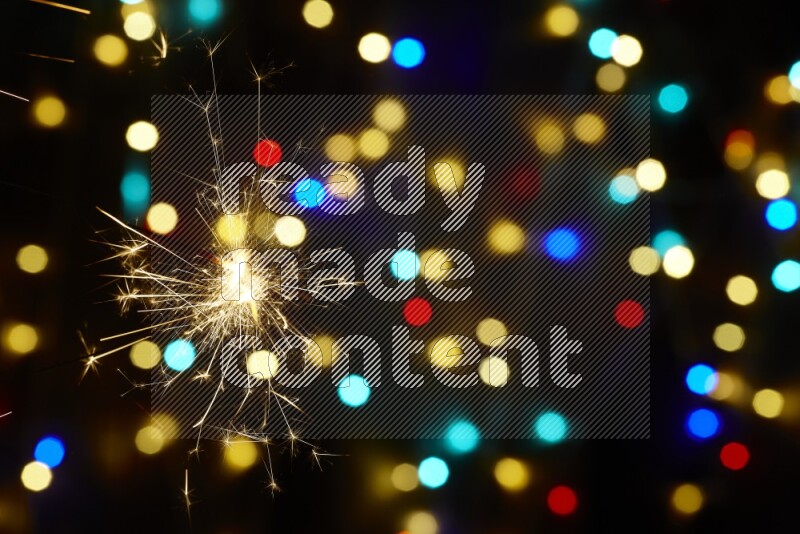 Sparkler candles with multicolored light bokeh background