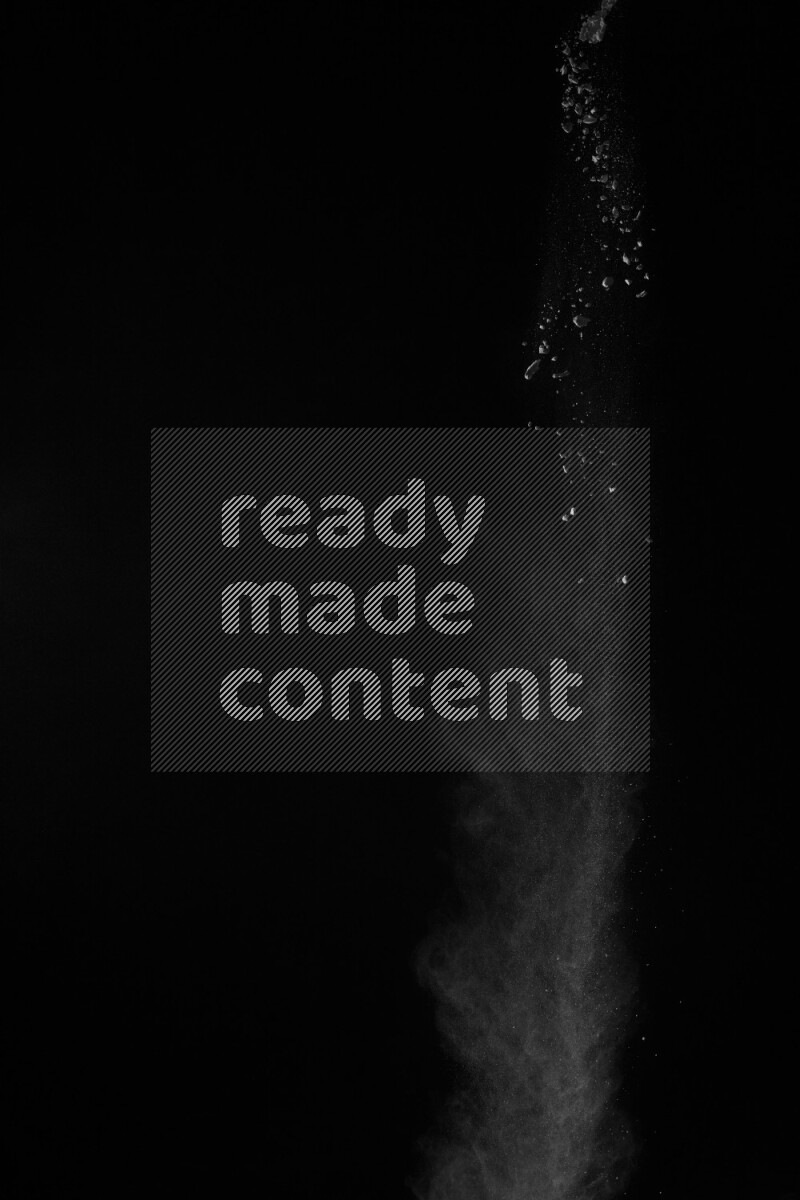 A side view of white powder explosion on black background