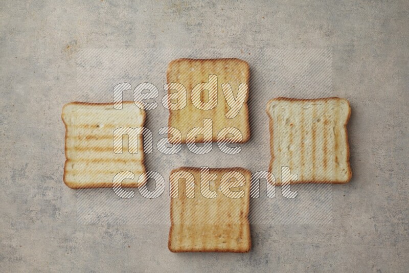Toasted white Toast slices on a light blue textured background
