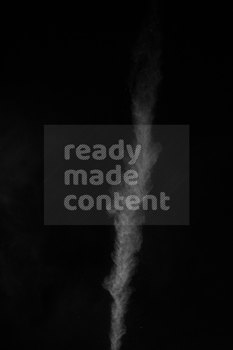 A side view of white powder explosion on black background