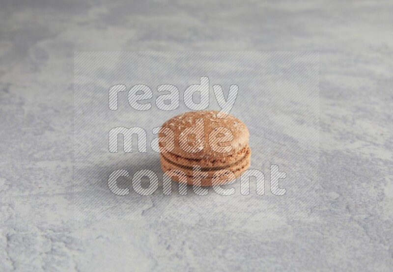 45º Shot of Brown Hazelnuts macaron on white  marble background