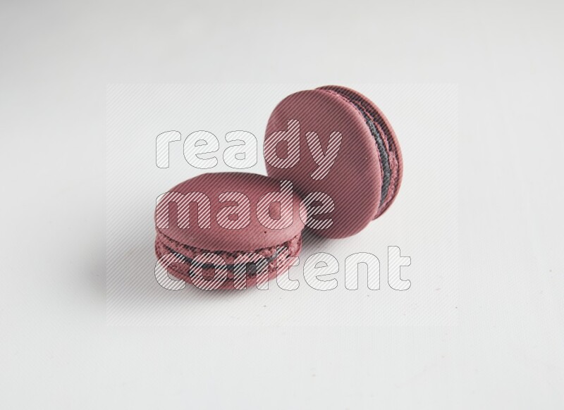 45º Shot of two Red Cherry macarons on white background