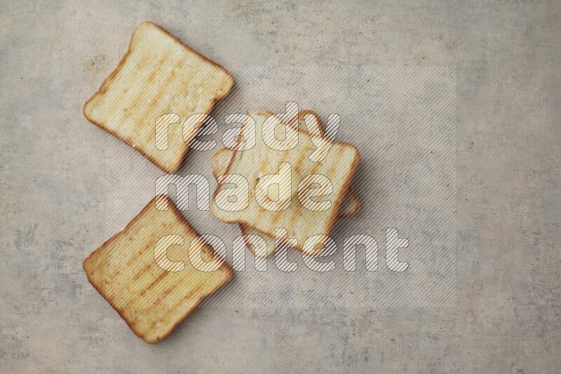 Toasted White Toast slices with a butter curl on a light blue textured background
