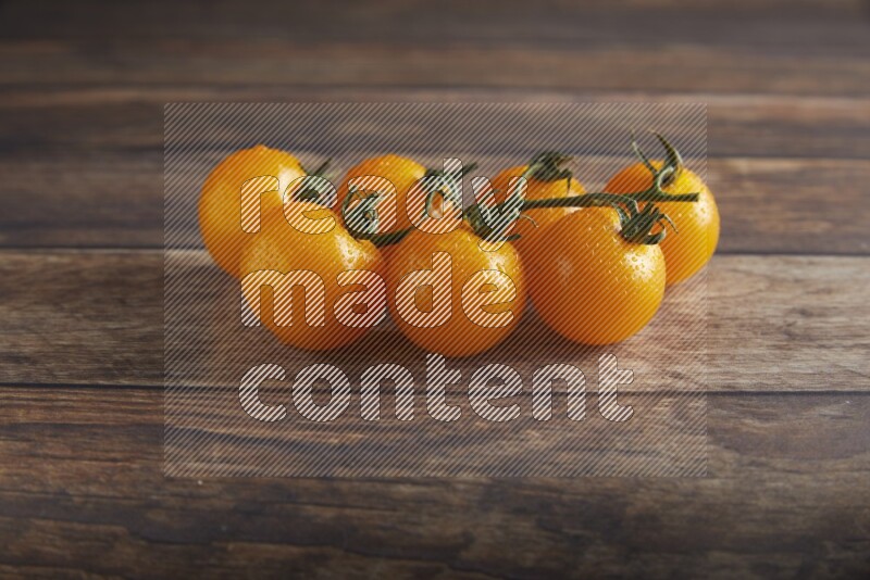 yellow cherry tomato vein on a textured wooden background 45 degree