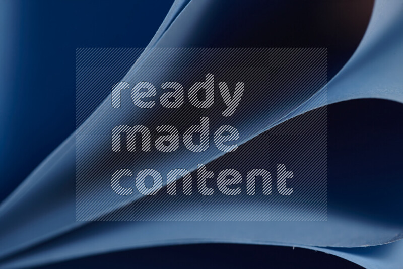 An abstract art showing blue paper sheets arranged in an overlapping curves