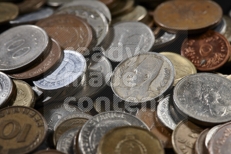 A close-ups of random old coins on black background