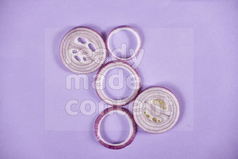 Red onions rings on purple background