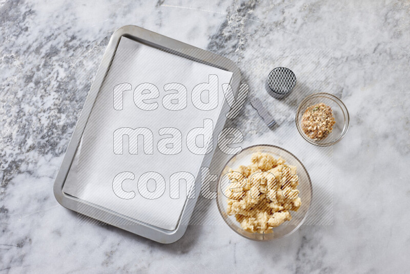 Kahk step by step with its ingredients ghee, sugar, flour, sesame, yeast, water and kahk flavor on grey marble background