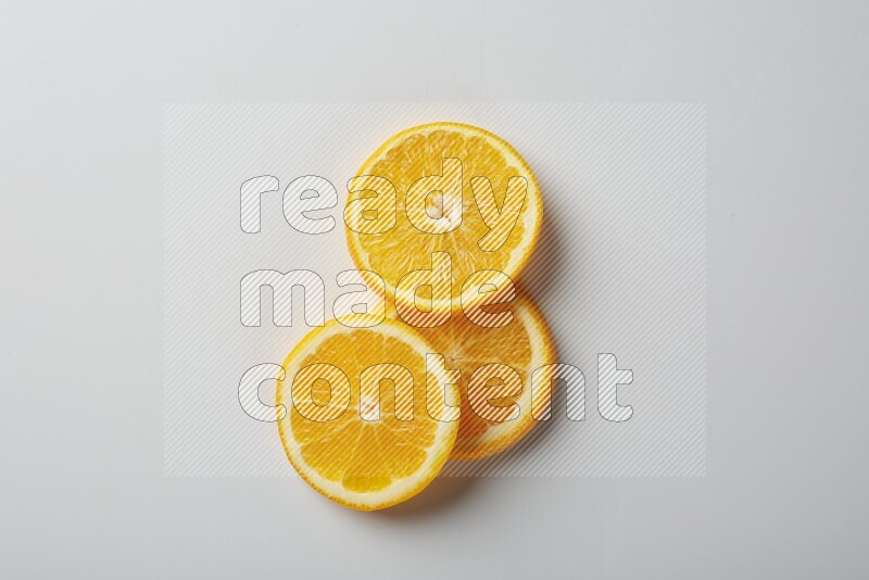 Three orange slices on a white background