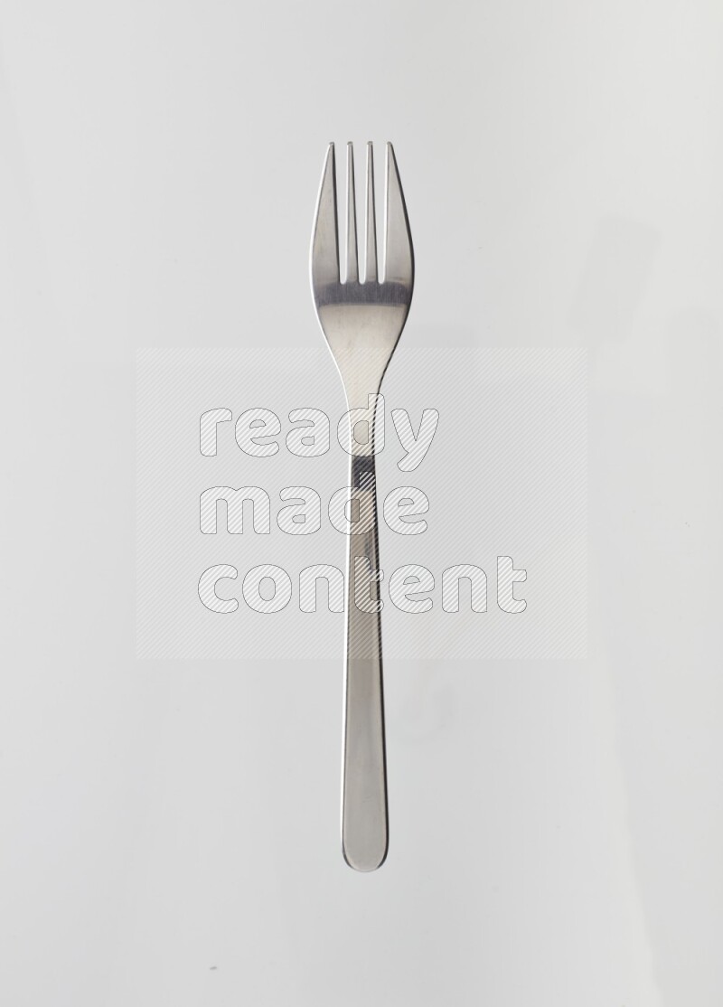 Silver stainless steel fork on white background