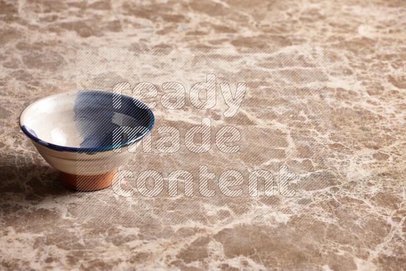 Multicolored Pottery Bowl on Beige Marble Flooring
