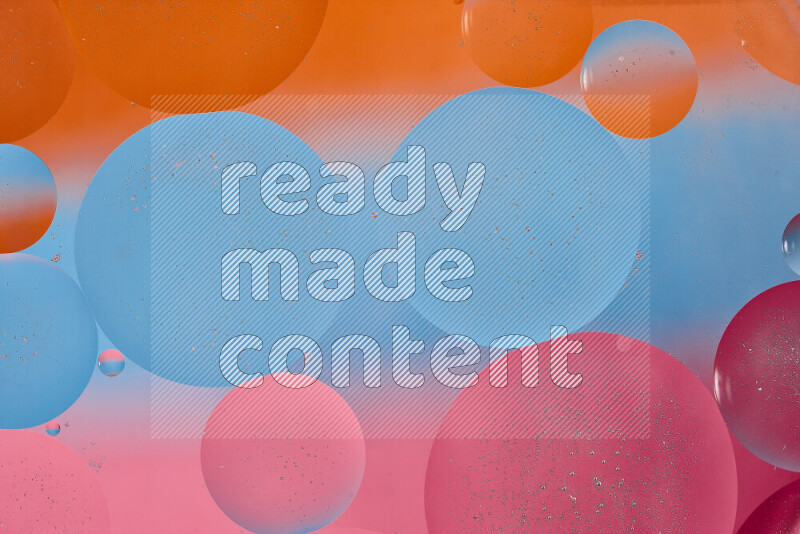Close-ups of abstract oil bubbles on water surface in shades of blue, orange and pink