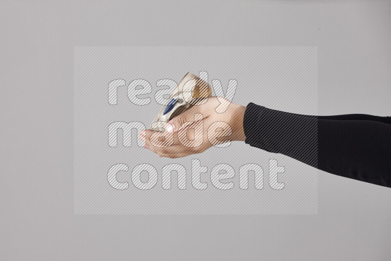 A woman in black abaya holding different pottery essentials in different positions