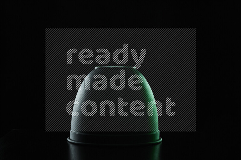 A reflector diffuser lamp shade dish with colored rim light against black background