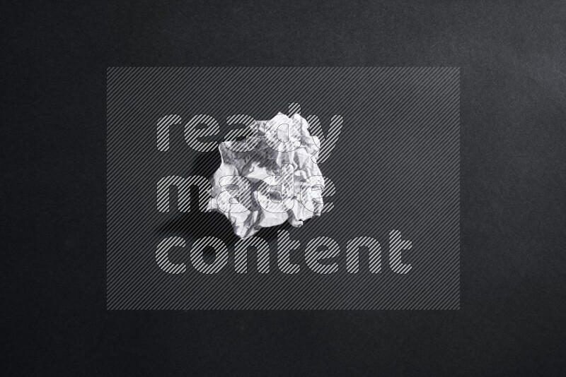Crumpled notebook sheet on black background