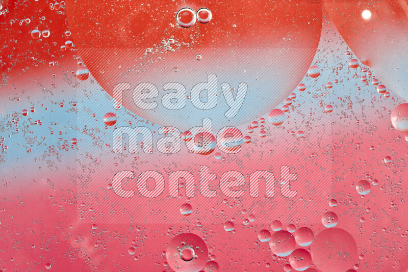Close-ups of abstract oil bubbles on water surface in shades of blue, red and pink