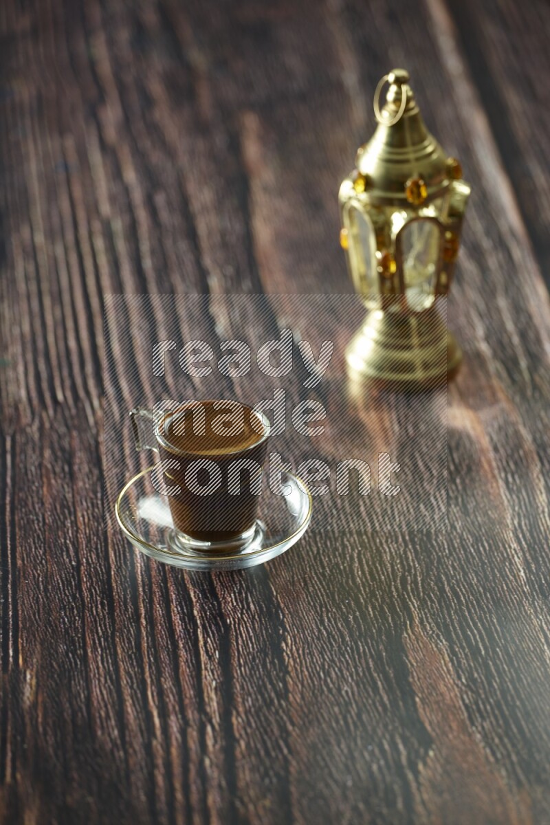 A golden lantern with different drinks, dates, nuts, prayer beads and quran on brown wooden background