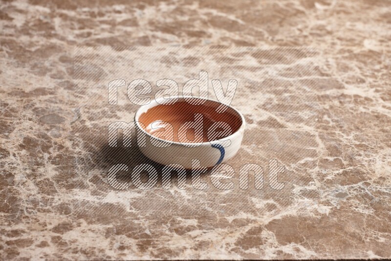 Multicolored Pottery Bowl on Beige Marble Flooring