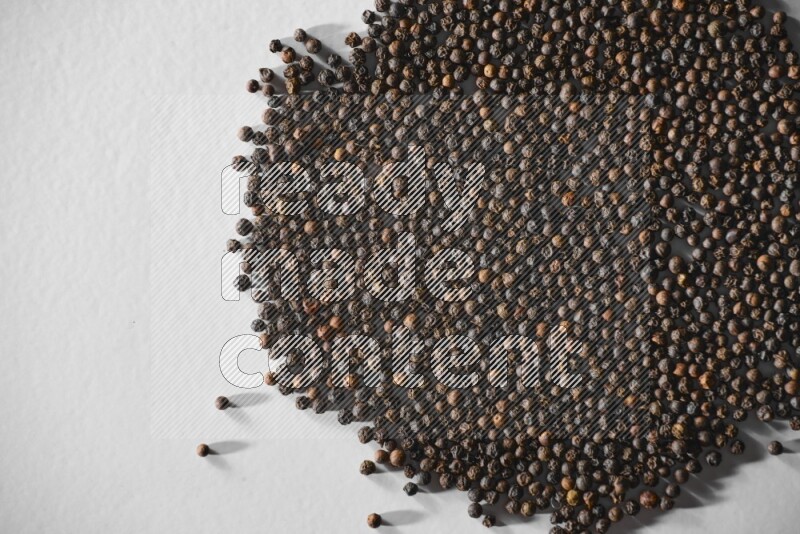 Black pepper on a white flooring