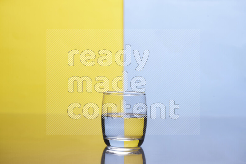 The image features a clear glassware filled with water, set against yellow and light blue background