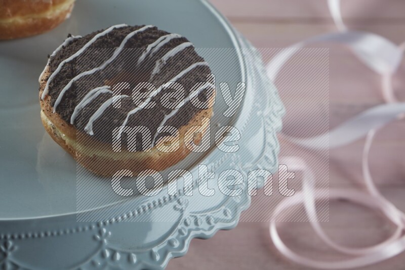 Chocolate crumbs doughnut on pink wooden background