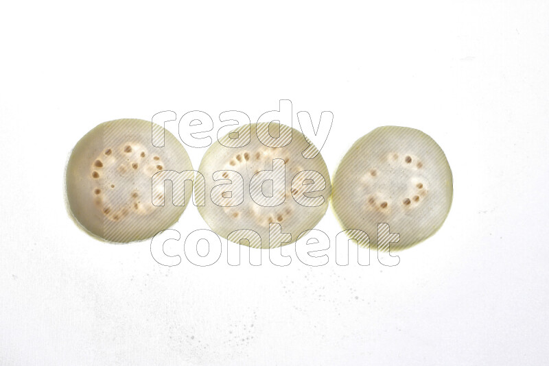 Guava slices on illuminated white background
