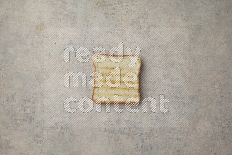 Toasted white Toast slices on a light blue textured background