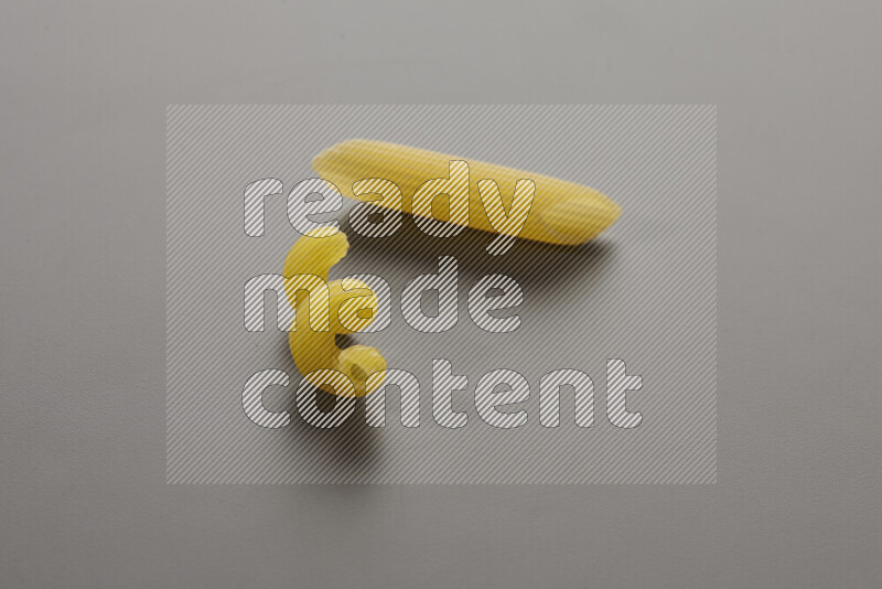 Twist pasta with other types of pasta on grey background