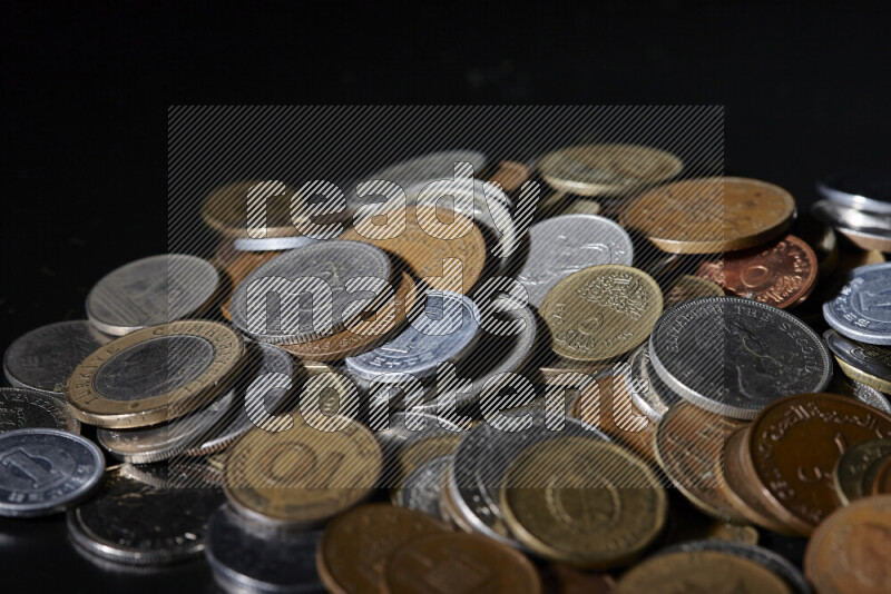 A close-ups of random old coins on black background