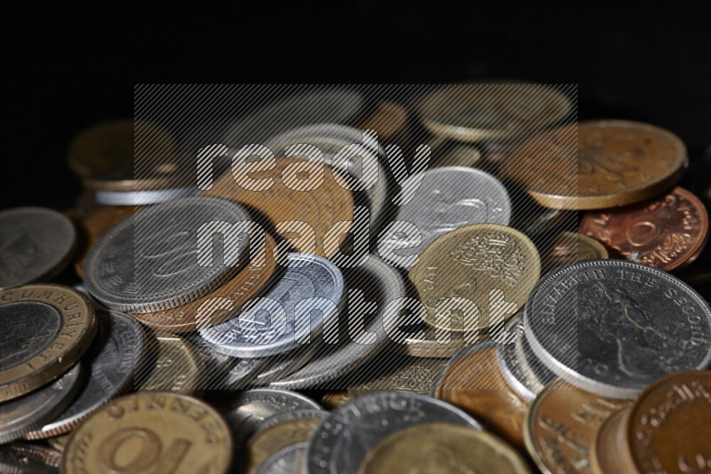 A close-ups of random old coins on black background