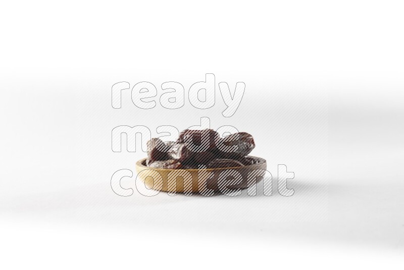 Dates in a wooden bowl on white background