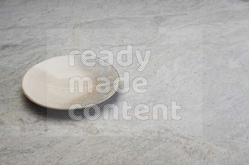 Multicolored Pottery Plate On Grey Marble Flooring