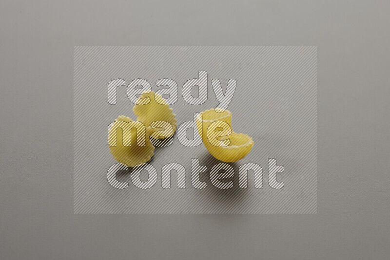 Fiocchi pasta with other types of pasta on grey background