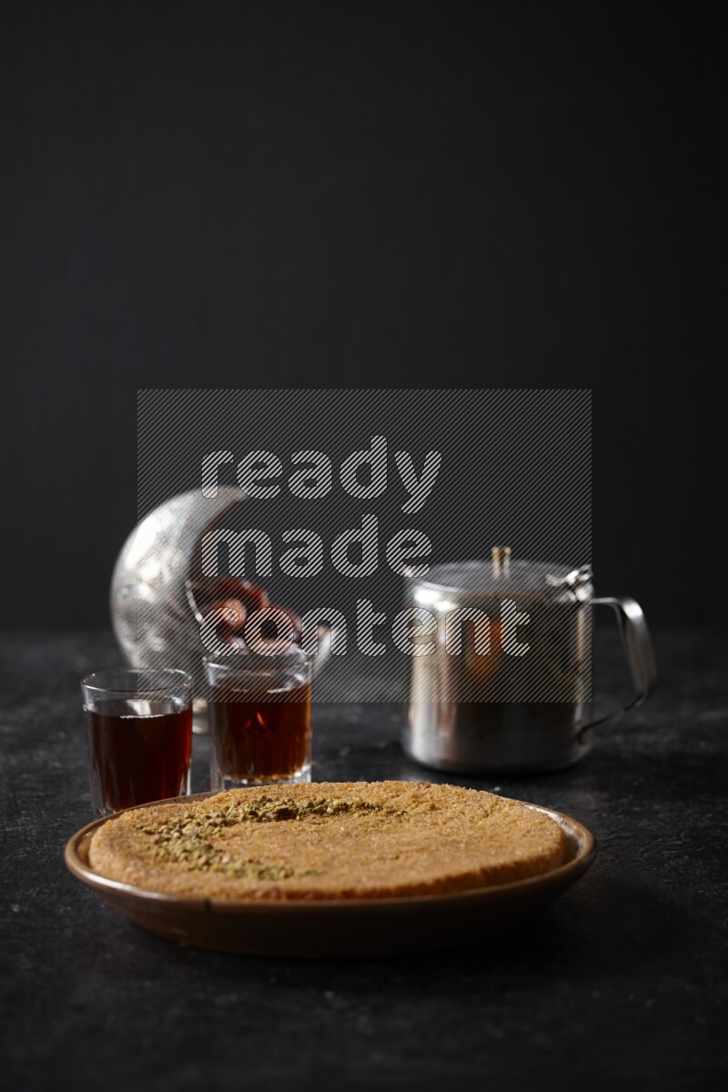 konafa with tea in a dark setup