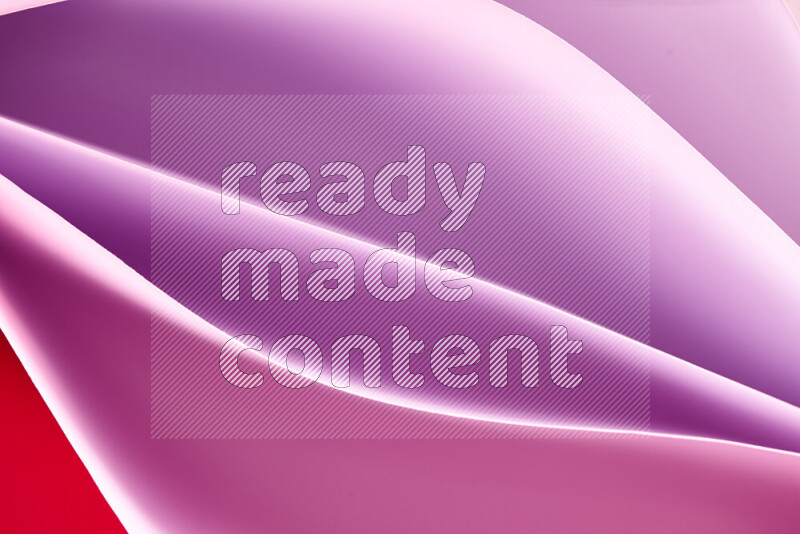 This image showcases an abstract paper art composition with paper curves in purple and pink gradients created by colored light