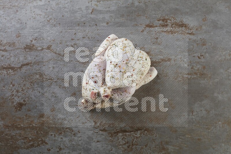 whole raw chicken  direct on a rustic grey background