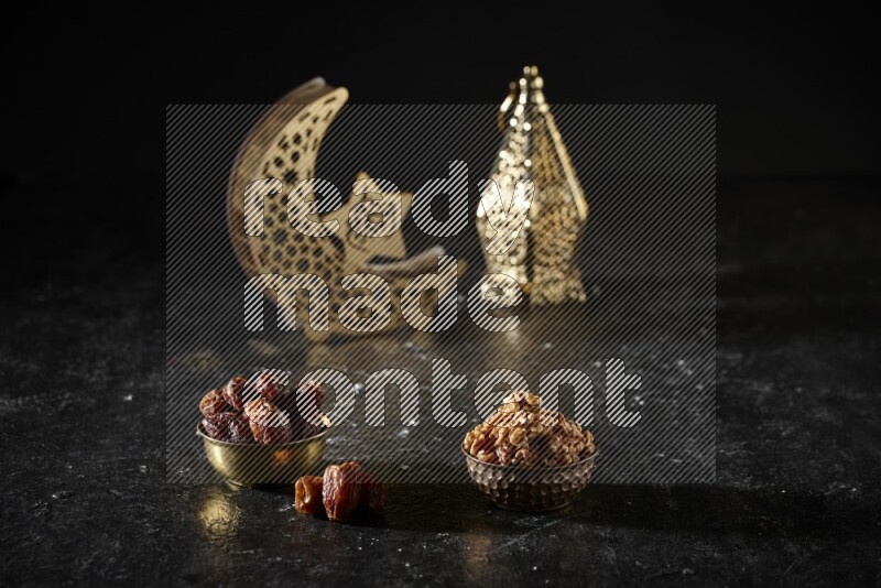 Dates in a metal bowl with walnuts beside golden lanterns in a dark setup