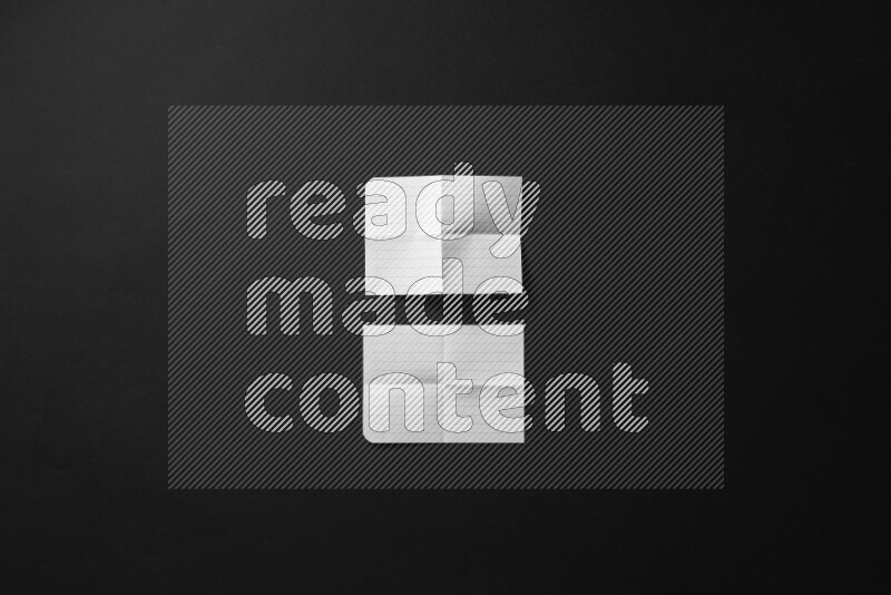 Ripped notebook sheet on black background