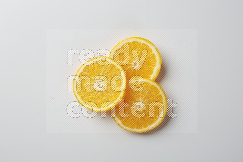Three orange slices on a white background