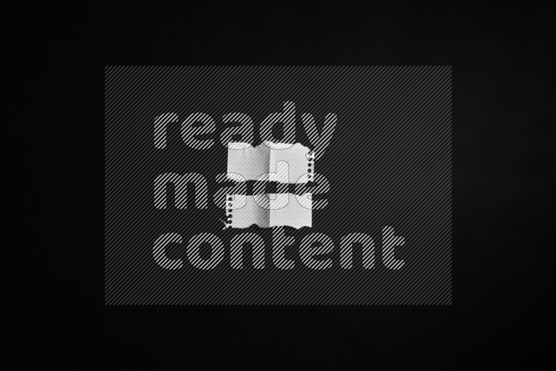 Ripped notebook sheet on black background