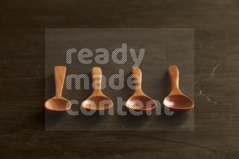 wooden spoon on black slate background