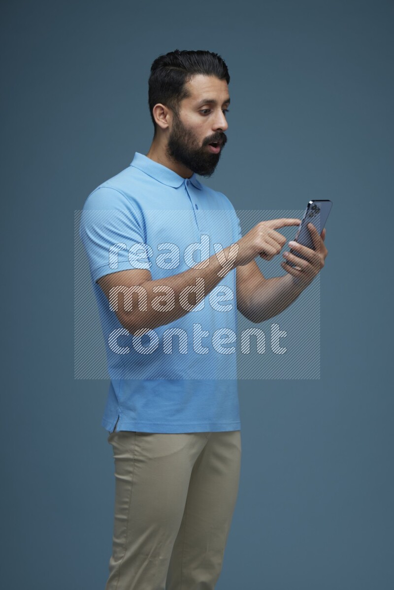 A man Swiping in a blue background wearing a Blue shirt