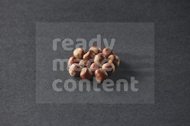 A bunch of hazelnuts on a black background in different angles