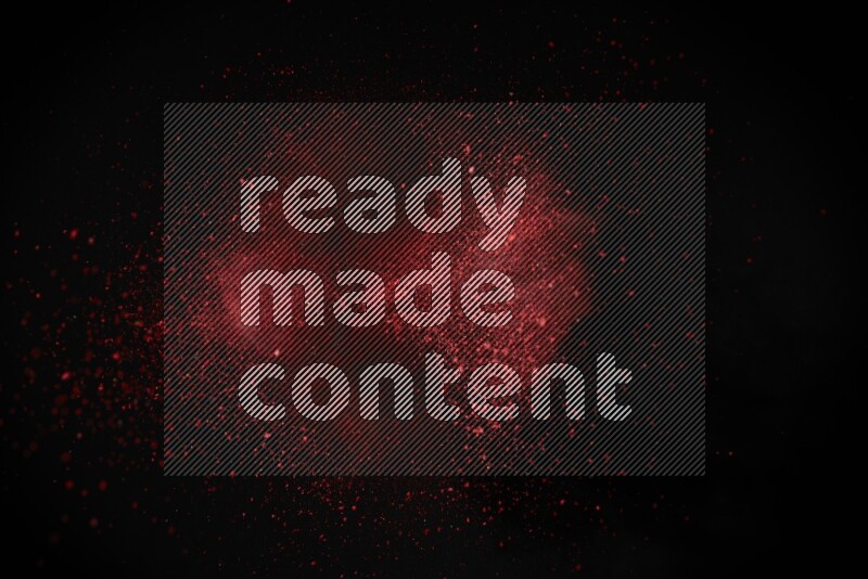Red powder explosion on black background