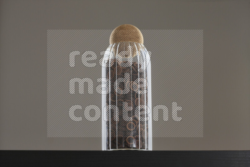 Buttons in a glass jar on black background